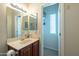 Bathroom with single sink, vanity, and access to a small closet at 20340 N Canyon Whisper Dr, Surprise, AZ 85387