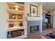 Fireplace with built-in shelving and decorative accents at 20340 N Canyon Whisper Dr, Surprise, AZ 85387