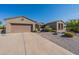 One-story home with desert landscaping and a two-car garage at 20340 N Canyon Whisper Dr, Surprise, AZ 85387