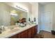 Bathroom with double sinks, a large mirror, and a walk-in shower at 20340 N Canyon Whisper Dr, Surprise, AZ 85387