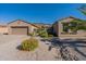 Single story home with a two-car garage and well maintained landscaping at 20340 N Canyon Whisper Dr, Surprise, AZ 85387