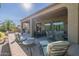 Spacious covered patio furnished with comfortable seating and a table at 20340 N Canyon Whisper Dr, Surprise, AZ 85387