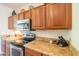 View of kitchen with wood cabinets, granite countertops, and stainless steel appliances at 20340 N Canyon Whisper Dr, Surprise, AZ 85387