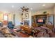 Spacious living room featuring a fireplace, comfortable seating, and built-in entertainment center at 20340 N Canyon Whisper Dr, Surprise, AZ 85387