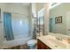 Bathroom with tub/shower combo, single sink vanity, and linen storage at 20340 N Canyon Whisper Dr, Surprise, AZ 85387