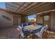 Covered patio with pergola, dining set, and access to the backyard at 20340 N Canyon Whisper Dr, Surprise, AZ 85387