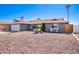 Front view of a ranch style house with a gravel driveway at 3425 W Acoma Dr, Phoenix, AZ 85053