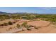 Aerial view showing a large vacant lot with mountain views and surrounding homes at 10610 E Stoney Cir, Scottsdale, AZ 85262