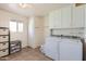 Laundry room with washer, dryer, cabinets, and storage space at 13605 N Redwood Dr, Sun City, AZ 85351