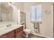 Clean bathroom with single sink vanity, shower, and linen storage at 13605 N Redwood Dr, Sun City, AZ 85351