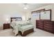 Cozy bedroom with double bed, wood furniture, and ceiling fan at 13605 N Redwood Dr, Sun City, AZ 85351