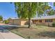 House exterior with a two-car garage and mature tree at 13605 N Redwood Dr, Sun City, AZ 85351