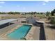 Large swimming pool with a spa and adjacent covered patio at 7329 N 173Rd Ave, Waddell, AZ 85355