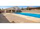 Relaxing pool area with flagstone patio and covered structure at 7329 N 173Rd Ave, Waddell, AZ 85355