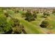 Aerial view of a lush green golf course with mature trees and a residential area in the background at 19826 N 129Th Dr, Sun City West, AZ 85375