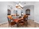 Bright dining room with wood table and chairs, and decorative wall accents at 7642 N 177Th Ave, Waddell, AZ 85355