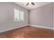 Simple bedroom with hardwood floors and a large window at 6125 E Hodges St, Cave Creek, AZ 85331