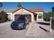 Single story home with brown garage door and landscaping at 5220 W Saragosa St, Chandler, AZ 85226