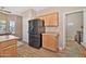 Kitchen with black refrigerator and light wood cabinets at 40708 N Apollo Way, Anthem, AZ 85086