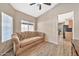 Cozy living room with a tufted couch and large window at 40708 N Apollo Way, Anthem, AZ 85086