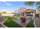 Landscaped backyard with fire pit and artificial turf at 46024 W Amsterdam Rd, Maricopa, AZ 85139