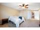 Bright bedroom with ceiling fan and ensuite bathroom access at 46024 W Amsterdam Rd, Maricopa, AZ 85139