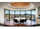 Stunning dining room with a round table, mountain views, and wood ceiling at 8877 E Charolais Dr, Scottsdale, AZ 85262