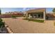 Landscaped backyard with covered patio, artificial turf, and gravel at 27571 N 171St Dr, Surprise, AZ 85387