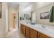 Double vanity bathroom with a large mirror and tiled floors at 27571 N 171St Dr, Surprise, AZ 85387