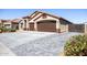 Two-car garage with a paver driveway and landscaped front yard at 786 W Jahns Dr, Casa Grande, AZ 85122
