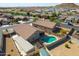 Aerial view of a house with a pool and detached garage in a residential neighborhood at 786 W Jahns Dr, Casa Grande, AZ 85122