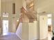 Elegant wooden staircase with a high ceiling and view of the entryway at 7117 W Globe Ave, Phoenix, AZ 85043