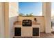 Close-up view of a built-in outdoor grill with tiled surround at 36382 N 35Th St, Cave Creek, AZ 85331