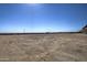 Large undeveloped lot with dirt and tire tracks at 29923 W Melvin St, Buckeye, AZ 85396