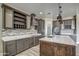 Modern kitchen with dark wood cabinetry, quartz countertops, and a large island at 29923 W Melvin St, Buckeye, AZ 85396