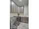 Laundry room with washer, dryer, cabinets and sink at 29923 W Melvin St, Buckeye, AZ 85396