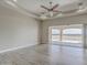 Spacious bedroom with wood-look tile floors and sliding glass doors leading to a patio at 29923 W Melvin St, Buckeye, AZ 85396
