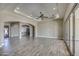 Spacious living room with wood-like tile floors, high ceilings, and views of entryway at 29923 W Melvin St, Buckeye, AZ 85396
