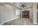 Living room with wood-look floors, ceiling fan, and built-in entertainment center at 29923 W Melvin St, Buckeye, AZ 85396