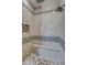 Large walk-in shower with tiled walls and built-in seat at 29923 W Melvin St, Buckeye, AZ 85396