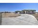 Single story home with a large driveway and desert landscaping at 29923 W Melvin St, Buckeye, AZ 85396