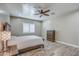 Bright bedroom with wood flooring, large window with plantation shutters, and ceiling fan at 29923 W Melvin St, Buckeye, AZ 85396