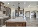 Gourmet kitchen with island, stainless steel appliances, and custom cabinetry at 29923 W Melvin St, Buckeye, AZ 85396