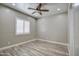 Spacious bedroom with wood-look tile flooring and ceiling fan at 29923 W Melvin St, Buckeye, AZ 85396