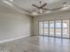 Spacious bedroom with wood-look tile floors and sliding glass doors leading to a patio at 29923 W Melvin St, Buckeye, AZ 85396