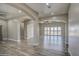 Open concept living room with wood-look tile floors and access to backyard at 29923 W Melvin St, Buckeye, AZ 85396