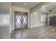 Elegant entryway with double doors and wood-look tile flooring at 29923 W Melvin St, Buckeye, AZ 85396