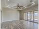 Spacious living room with wood-like tile floors, high ceilings, and sliding doors to patio at 29923 W Melvin St, Buckeye, AZ 85396