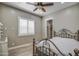 Bedroom with a ceiling fan and large window with plantation shutters at 29923 W Melvin St, Buckeye, AZ 85396
