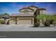 Two-story house with three-car garage and desert landscaping at 18516 W Sweet Acacia Dr, Goodyear, AZ 85338